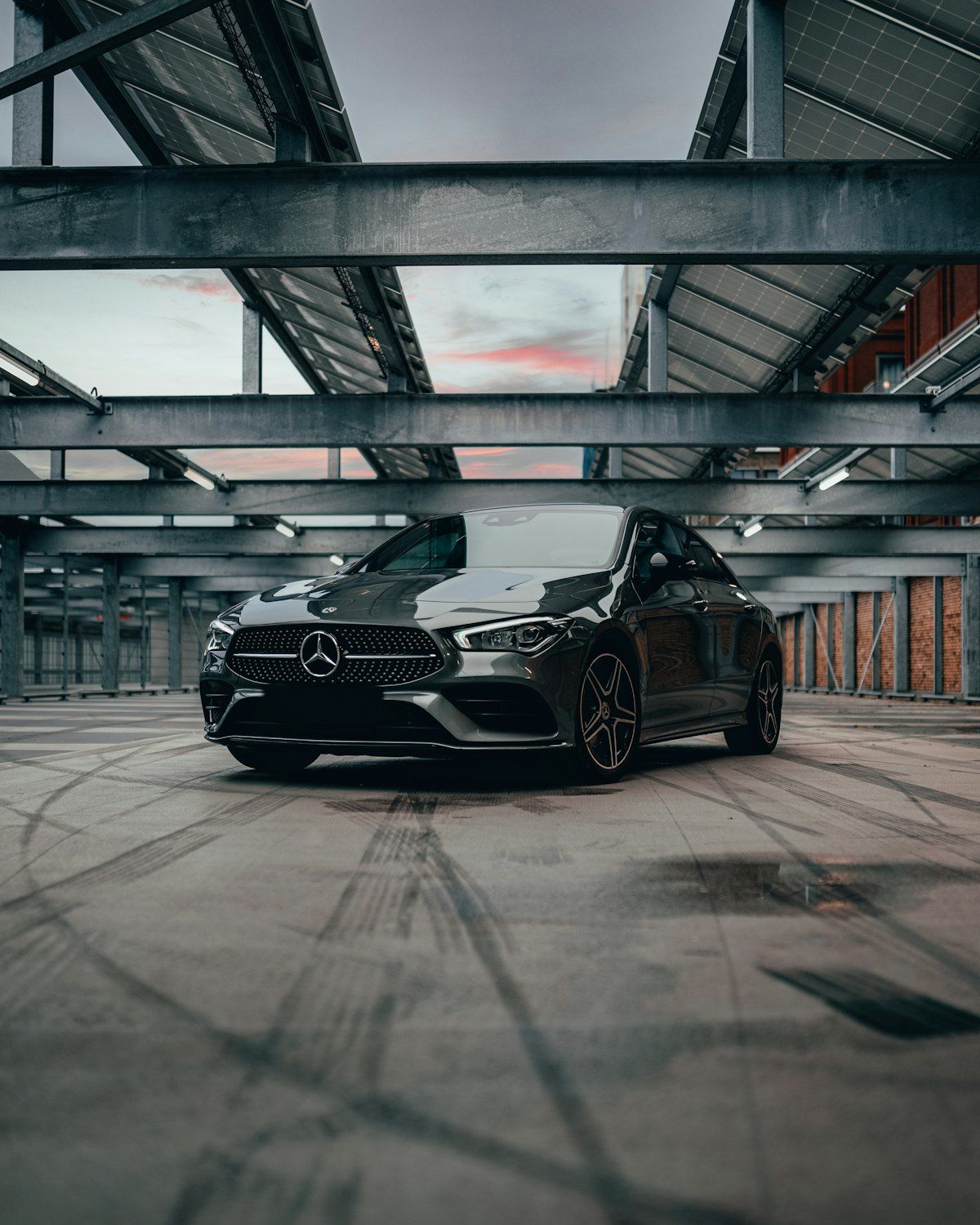 Stand-in Unsplash photo of a black Mercedes in an industrial hall