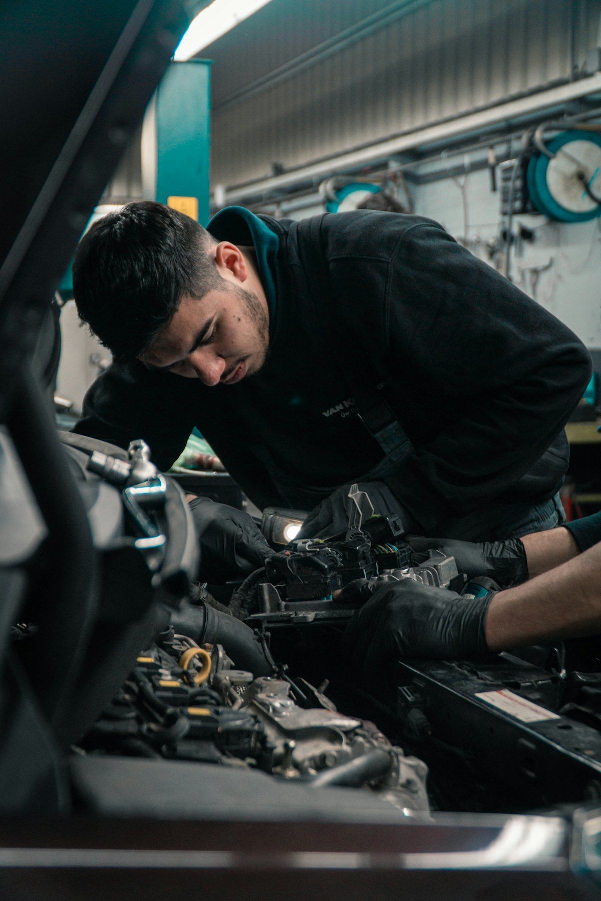 Stand-in Unsplash photo of a mechanic working on an engine